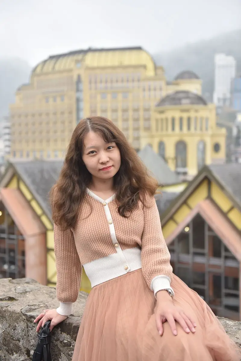 Portrait of a woman with an architectural city backdrop.