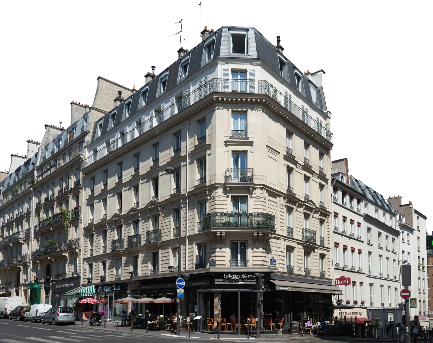Stone corner building at 22 Rue des Écoles in Paris, with balconies, a mansard roof, and a café at street level.